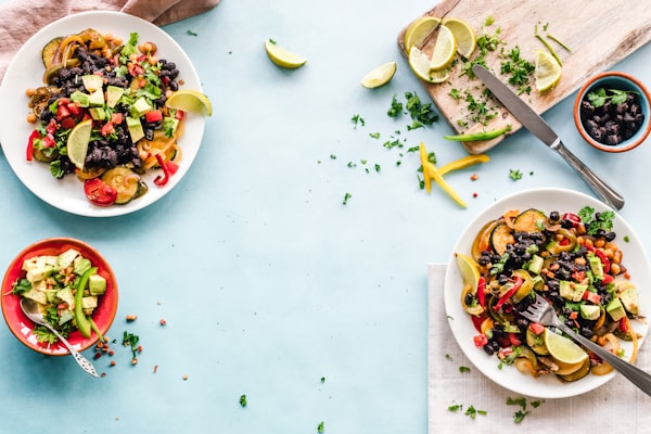 Plates of colorful Latin food on a shared table