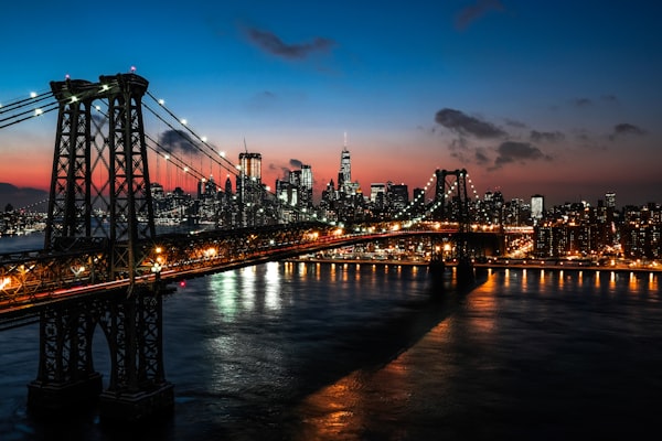 Williamsburg Bridge and Brooklyn skyline at dusk